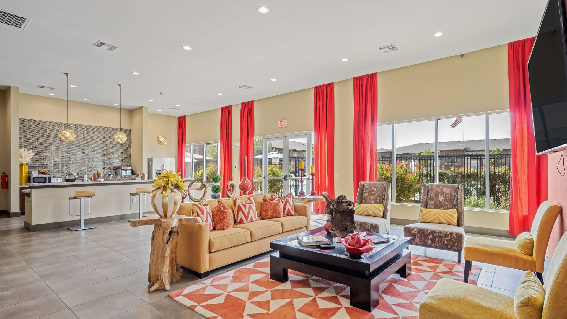 the living room has a large window and red curtains at The Anatole at City View