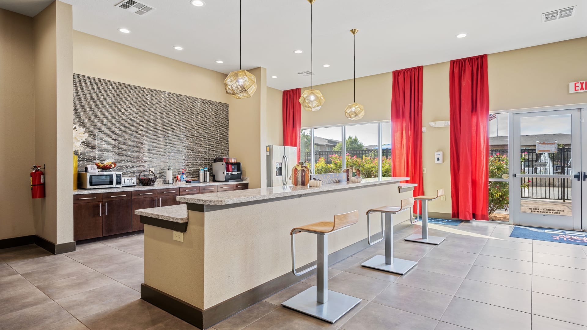 a large open kitchen with red curtains and a large counter at The Anatole at City View