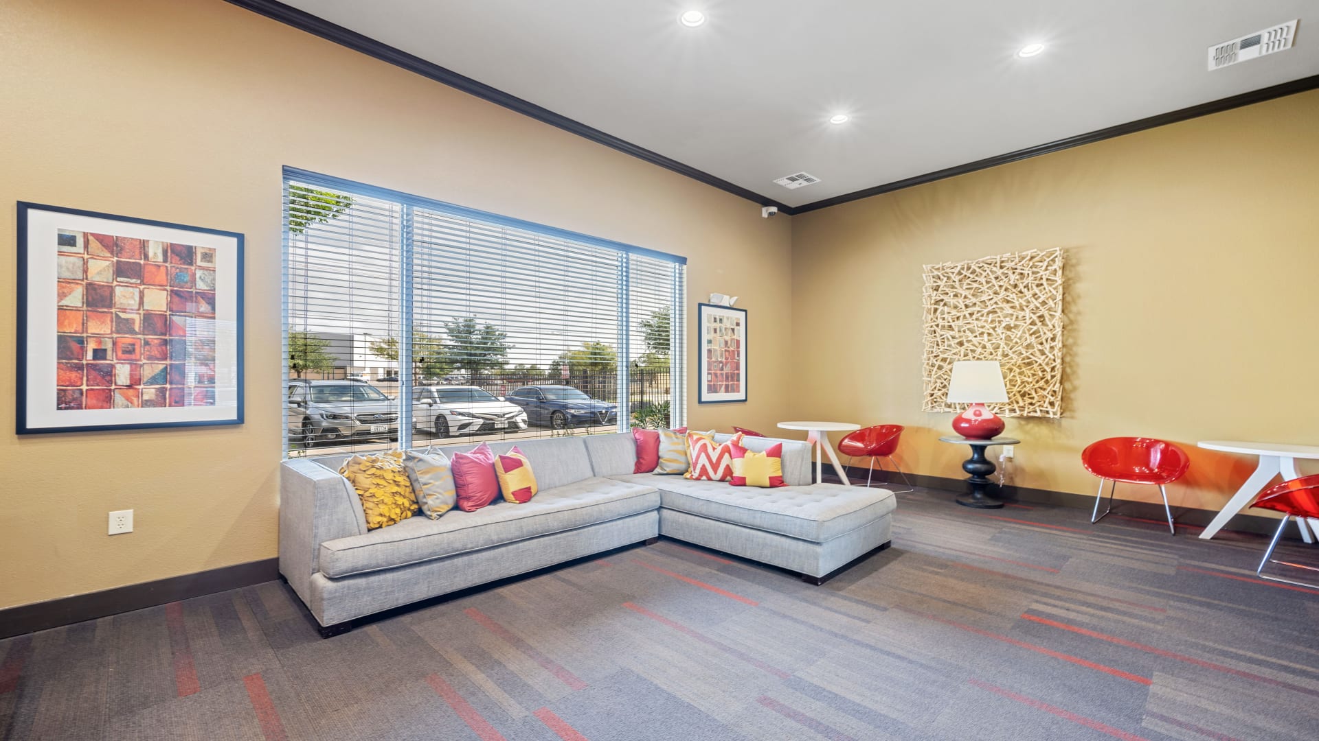 a large living room with couches and a large window at The Anatole at City View