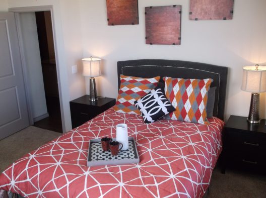a bedroom with a bed, nightstands and pictures at The Anatole at City View