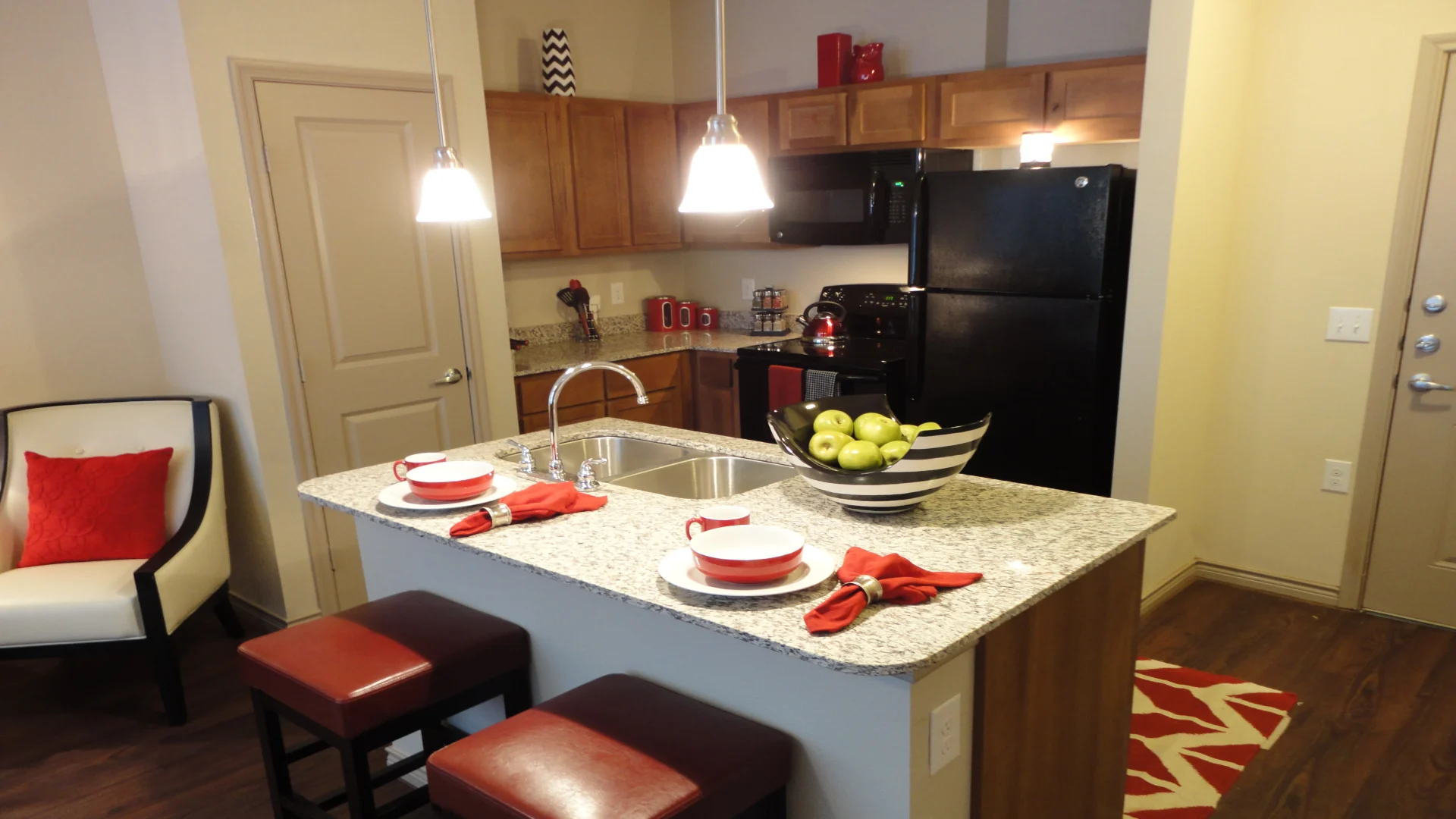 a kitchen with a stove, refrigerator, and sink at The Anatole at City View