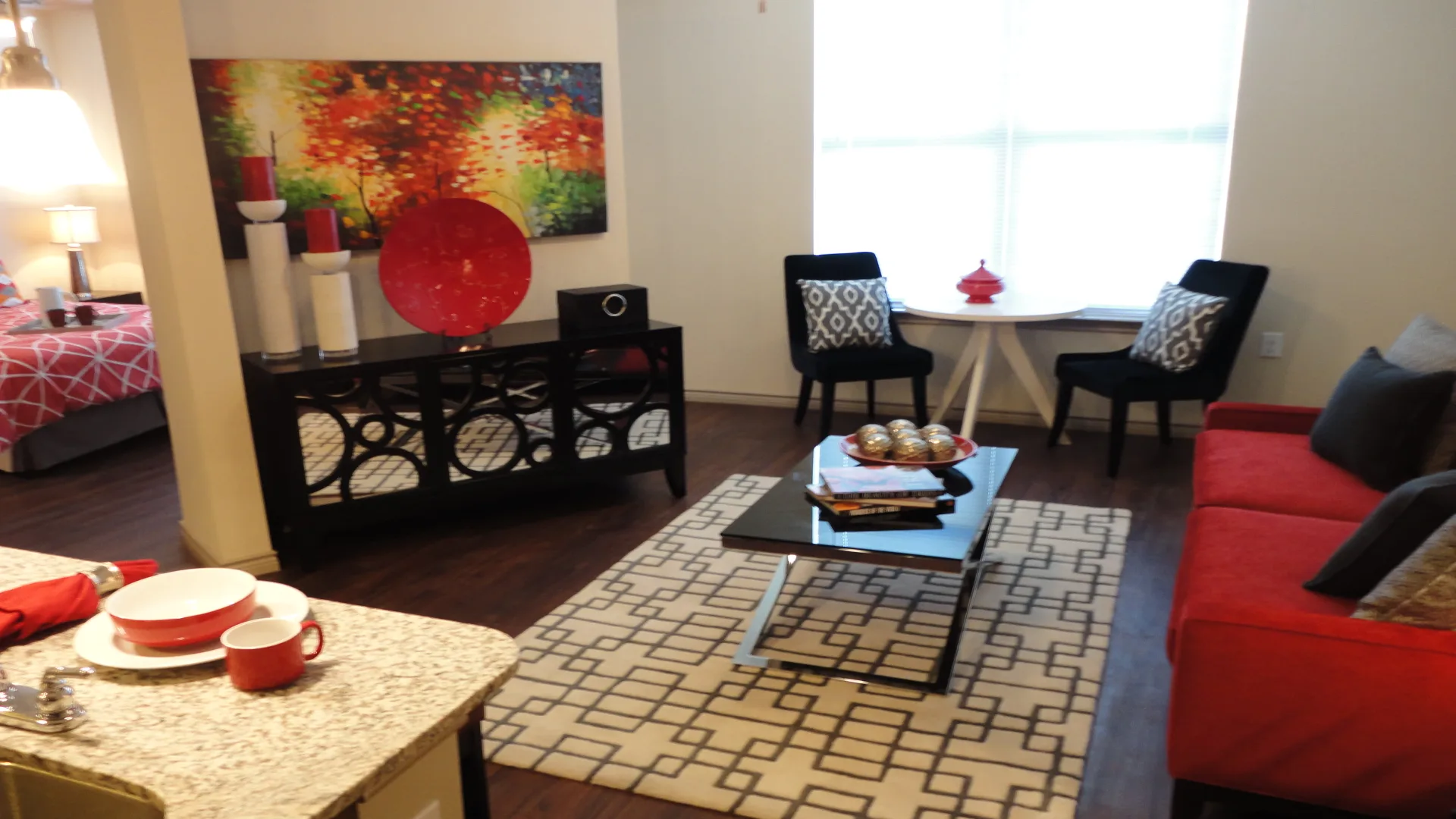 a living room with red couches and a coffee table at The Anatole at City View