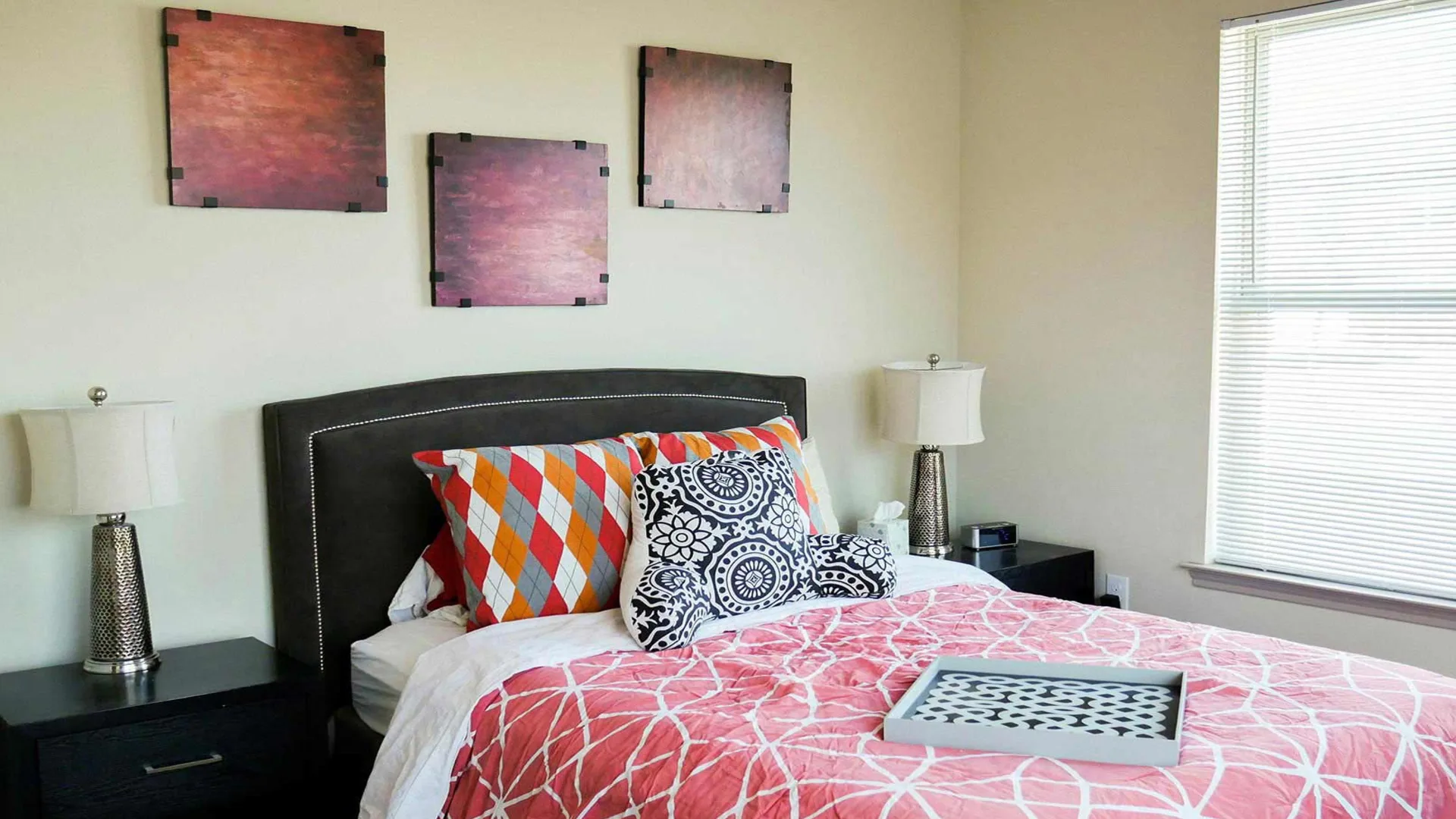 a bedroom with a bed, nightstands and a lamp at The Anatole at City View