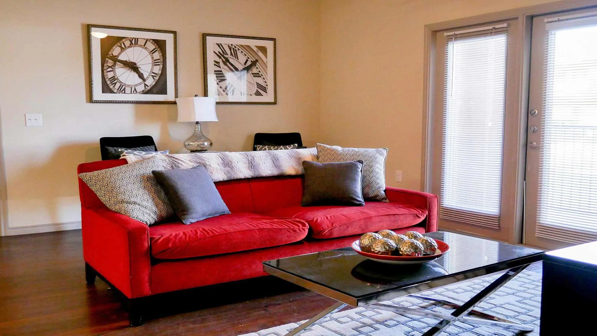 a living room with a red couch and coffee table at The Anatole at City View