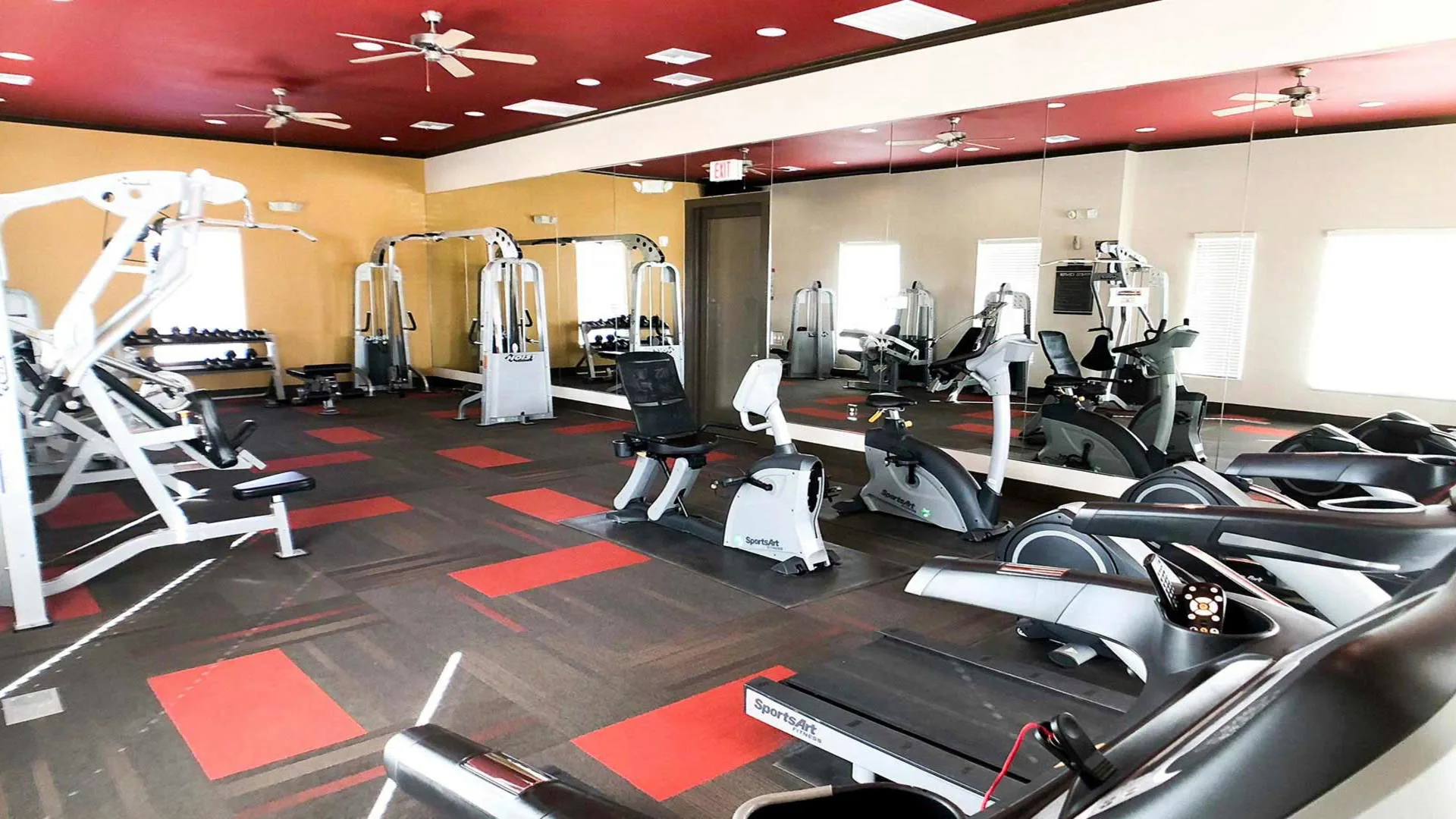 a gym room with treadmills, weights and other equipment at The Anatole at City View