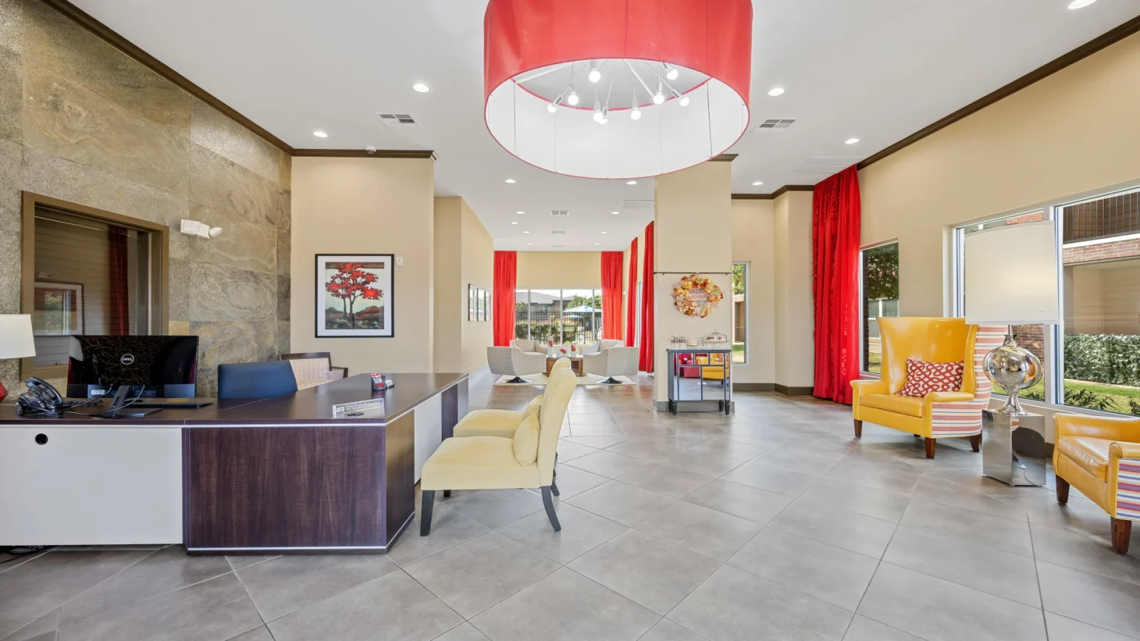 the lobby of a hotel with red and yellow accents at The Anatole at City View